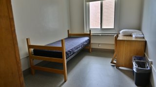 A single room in Whitman hall featuring an XL twin bed, desk, and wardrobe.