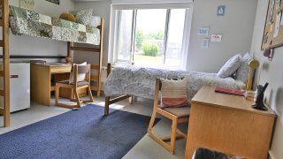 A double room in Whitman Hall featuring two XL twin beds and desks.
