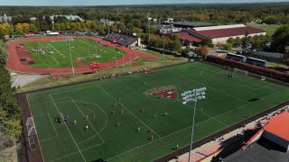 Alt text: Aerial view of St. Lawrence University's athletic complex, with soccer and football games taking place simultaneously on adjacent fields during a sunny fall day.