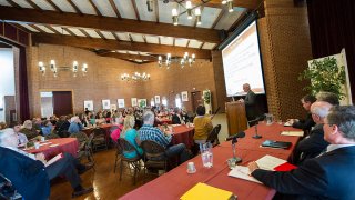 The main section of Eben Holden Dining Center featuring a conference presentation.