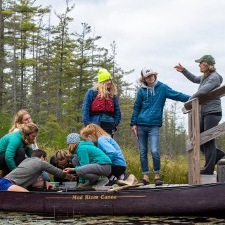 Faculty member teaching class on a dock