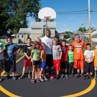 Laurentian student with youth on basketball court