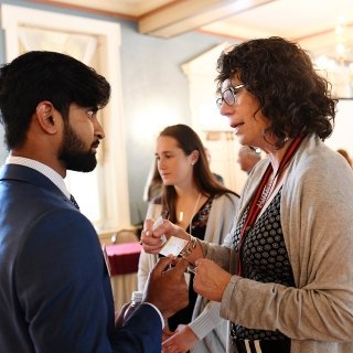 Alumna giving student their business card