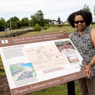 Faculty member standing by marker