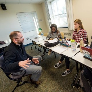 Faculty member speaking with students