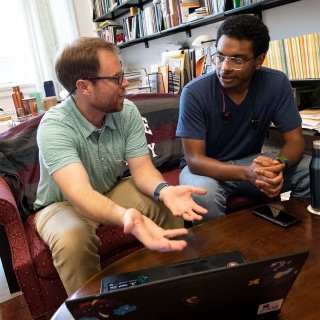 Faculty member and student talking in office