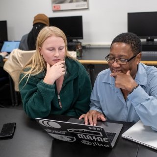 Faculty member helping a student