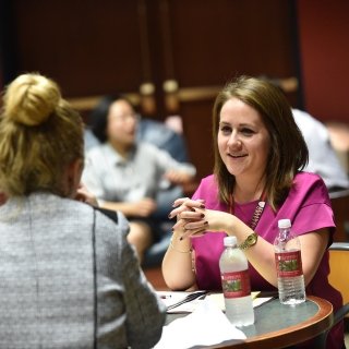 Alumna speaking with a student