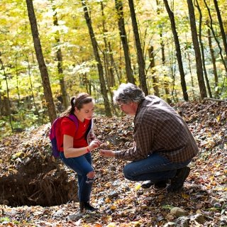 Faculty member and student doing field work