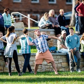 Student throwing atlatl
