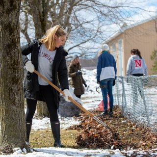Student raking leaves