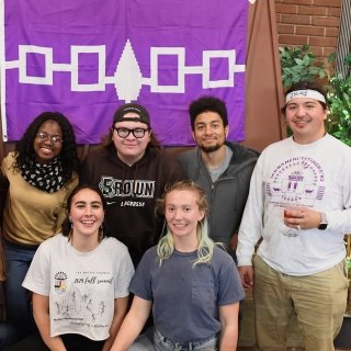 Students in front of an Akwesasne flag