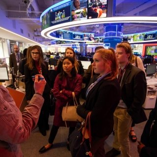 Students in a newsroom on a networking trip to New York City.