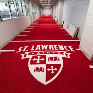 St. Lawrence Saints logo on a red carpet lined for workouts with markers