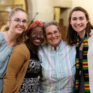 Rev. Kathleen Buckley with three students