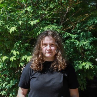 Photo of Emma with a green backdrop