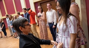 New member of Phi Beta Kappa receives cord from Professor Nadia Marano