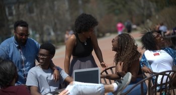Hana Bushara laughs with a group of Saint Lawrence friends on campus.