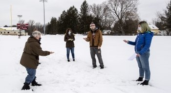 Faculty member doing experiment with students in the snow