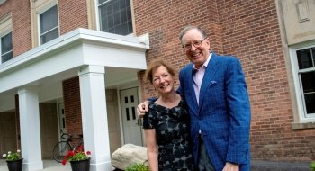 Bill and Lynn Fox stand in front of the newly named Fox Hall.