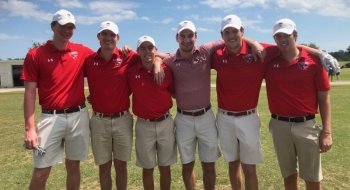 Six members of the Saint Lawrence University men's golf team. They all wear red golf shirts and khaki shorts.