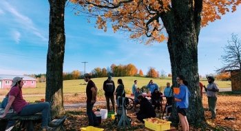 A group of Saint Lawrence students, participating in the Green Cafe class, gather at the Farm at Kirk Douglas for a meeting.