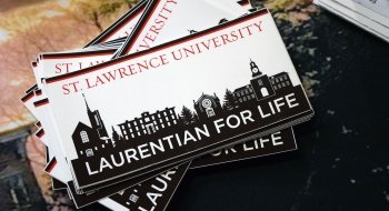 A stack of bumper stickers with &quot;Laurentian for Life&quot; and the Saint Lawrence University skyline on them.