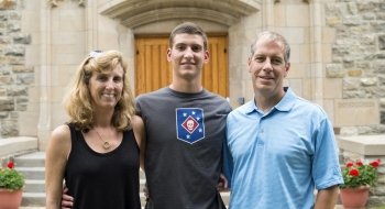 Two alumni with student