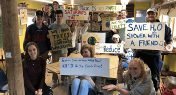 Saint Lawrence students hold various environmental action signs for climate change awareness.