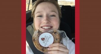 Eliza Maher holds a Saint Lawrence pub cookie.