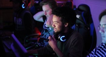 Students play esports in a dark room.