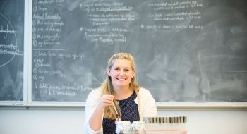 Katie Miller sits at a table with several samples.