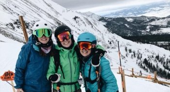 Olivia Hart, Monica Manning, and Kirsten Gehl skiing atop Big Sky, Montana.
