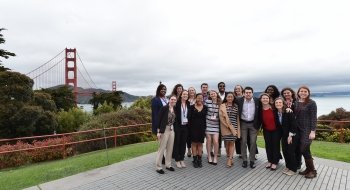 A group of Saint Lawrence students, attending a St. Lawrence University career connections event, stand in front of the Golden Gate bridge in California.