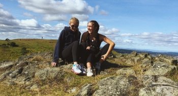 Two Saint Lawrence students sit on the ground in Edinburgh, Scotland.