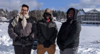 Three Saint Lawrence students stand outside in the snow at the annual Winter Carnival Event in Saranac Lake, NY.