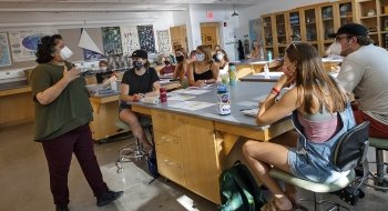 Aswini Pai, a biology professor, teaches a masked biology class attended by several engaged students.