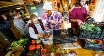Saint Lawrence University students organize fresh produce in the kitchen during the Adirondack Semester.