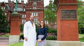 Morgan O'Hare stands outside of The Johns Hopkins Hospital with alumnus Doctor Robert Montgomery.