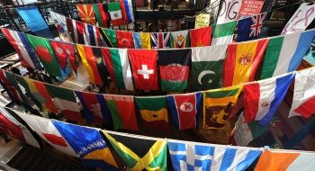 A photo of dozens of different countries' flags hanging up in the student center.