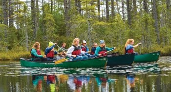 A photo of St Lawrence students canoeing on a lake.