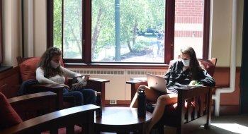 Students sitting looking at laptops