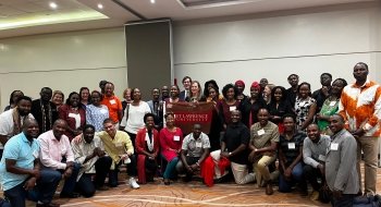 President Morris joins together with a large group to celebration the announcement of a large monetary gift that will fund the Ken Okoth Black American Music Project.