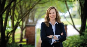 President Morris standing in front of campus