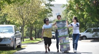 Family members helping a student move their stuff into the dorms
