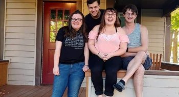 A photo of several Barista members on their house's front porch.