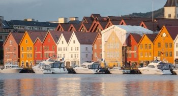 Colorful orange and red buildings along the seaside in a coastal town in Denmark.