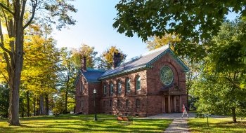 Student walking in front of Herring Cole.