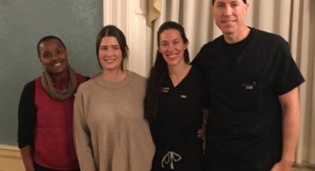 four physians posing for picture