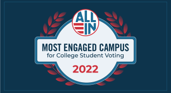 A graphic of a blue seal from the non-profit &quot;All In.&quot; It reads &quot;Most Engaged Campus for College Student Voting 2022.&quot;
